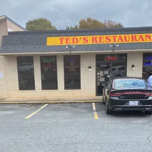 a car parked in front of the restaurant