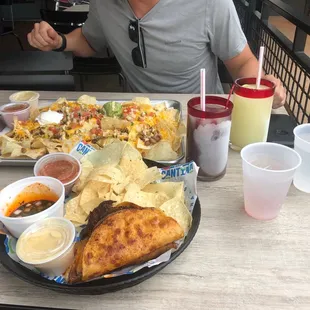 Birria tacos, Fajita Steak Nachos, Sangria and margarita swirl, and Frozen house margarita
