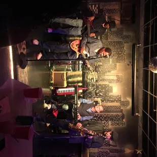 a group of people standing around a bar