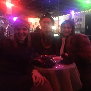 three people sitting at a table