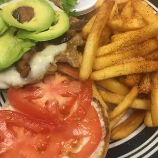 Grilled chicken sandwich with bacon and avocado. Fries are seasoned perfectly!