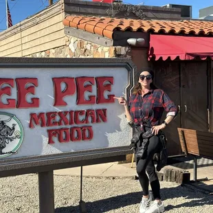 a woman standing in front of a sign