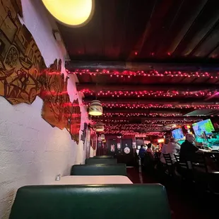 Inside of bar red Christmas lights and booths