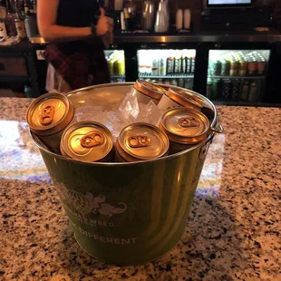 a bucket of beer on a counter