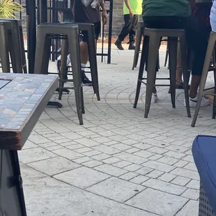 a group of people sitting at outdoor tables