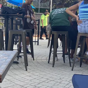 a group of people sitting at outdoor tables