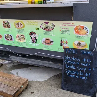a menu on the sidewalk