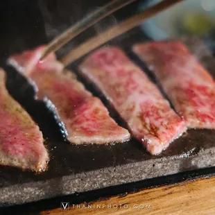 bacon being cooked on a grill