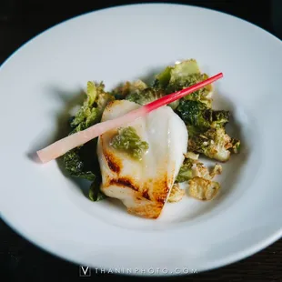 scallops and broccoli on a white plate