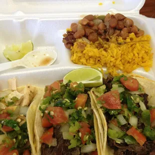 Barbacoa and chicken tacos with rice and charro beans