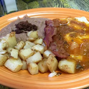 Abuelita&apos;s Huevos Rancheros, refried beans garnished with fried chorizo, and homemade corn tortillas!