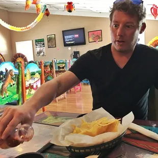 a man sitting at a table with food