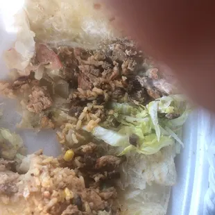 a close up of a taco in a styrofoam container