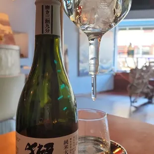 a bottle of sake and a glass of water