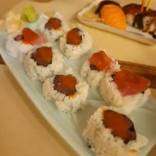 a plate of sushi and chopsticks