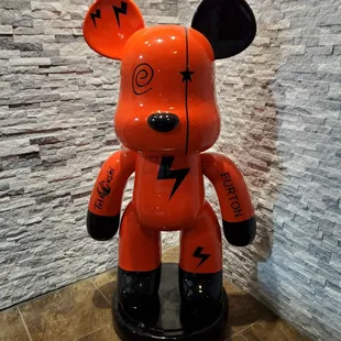 a red bear with lightning bolts on it