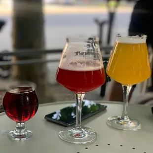 three glasses of beer on a table