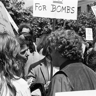 Protesters at entrance of U.C. Berkeley campus with signs that protest Nixon and bombs. - - -Tom Brody