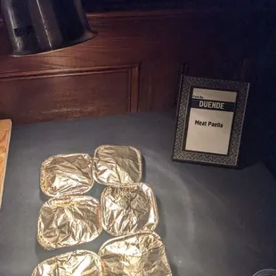 four pieces of foil on a table