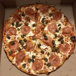 a pizza with pepperoni and olives