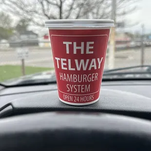 a cup on the dashboard of a car