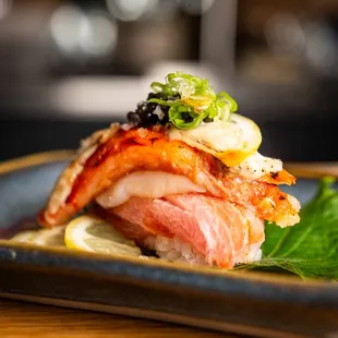 The BIGGIE specialty nigiri- Bluefin Toro, Hokkaido Scallop, Truffle Buttered King Crab, Estate Caviar, Nikiri, Negi, Citrus.