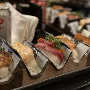 (New) Temaki handroll combo. Seared salmon, scallop, yellowtail, chopped salmon, and spicy tuna (left to right).