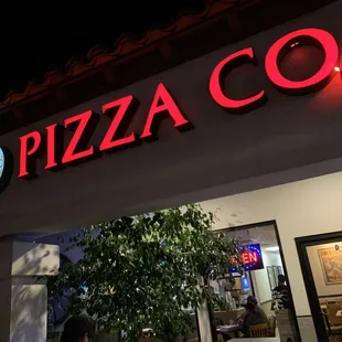 a woman walking in front of a restaurant