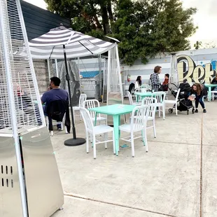 a patio with tables and chairs