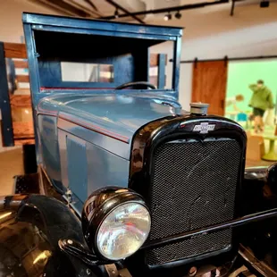 Kids may climb in and play in the bed of this old farm truck.