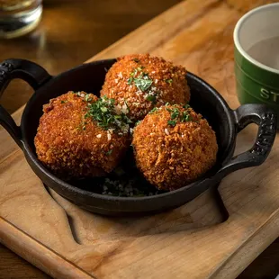 deep fried meatballs in a cast iron skillet