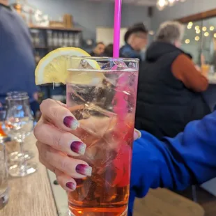 a woman holding a drink