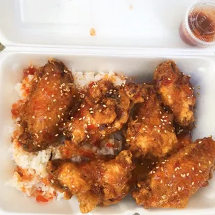 chicken wings and rice in a styrofoam container