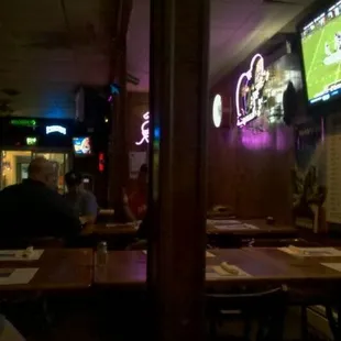 people sitting at a table watching a football game