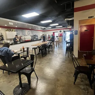 the inside of a restaurant with tables and chairs