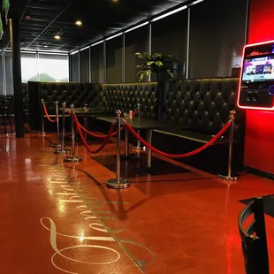 a red neon sign on the floor of a restaurant
