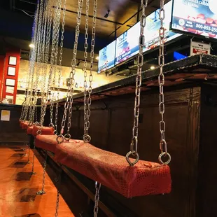 a bar with chains hanging from the ceiling