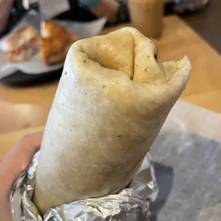 a burrito wrapped in aluminum foil