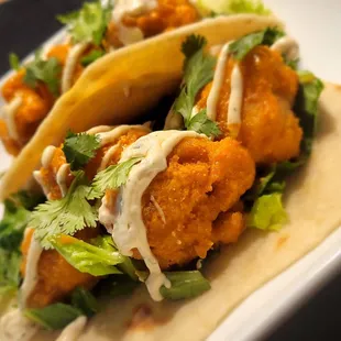 Buffalo Ranch Tacos served with hand breaded cauliflower tossed in house made spicy buffalo sauce, shredded lettuce-kale blend and ranch.