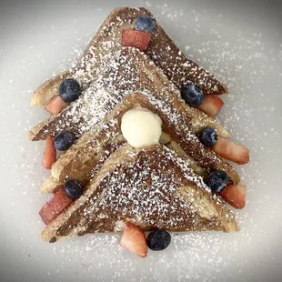 French toast with cinnamon, vanilla, butter, and seasonal fruit.