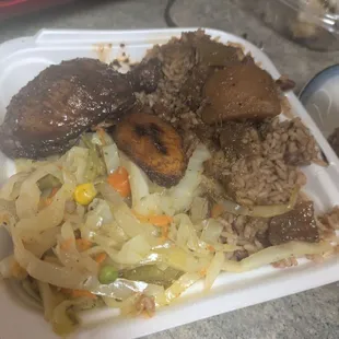 Jerk chicken (authentic Jamaican style) rice and peas cabbage and plantain.