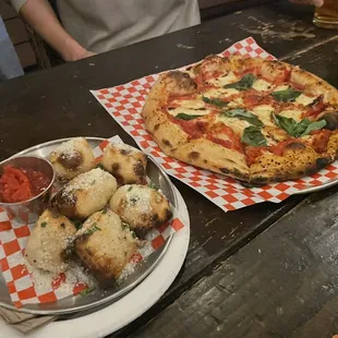a pizza and breadsticks on a table