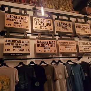 a variety of beer bottles hanging on a wall
