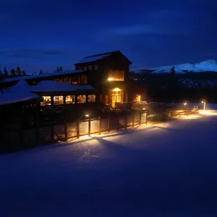 a ski lodge lit up at night