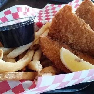 Fried fish and fried potato strips. I think they forgot to fry the lemon wedge and the tartar sauce.