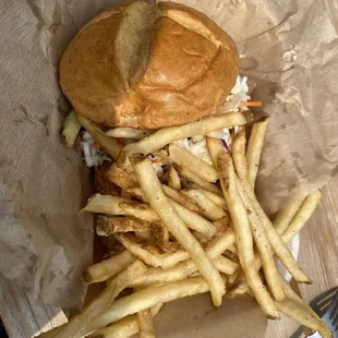 Chicken sandwich with coleslaw and french fries