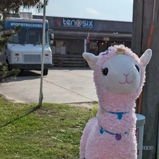 a stuffed llama on a pole
