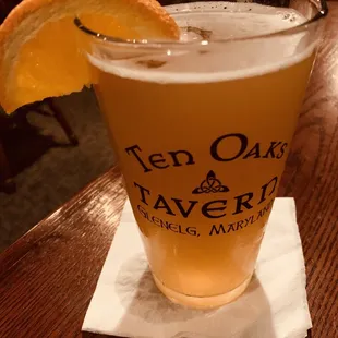 a glass of beer on a napkin
