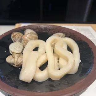 a plate of squids and clams on a table