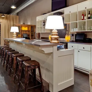 a bar with stools and a television